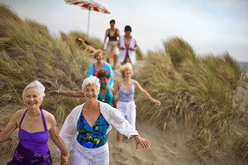 Happy mature friends enjoying a day at the beach.