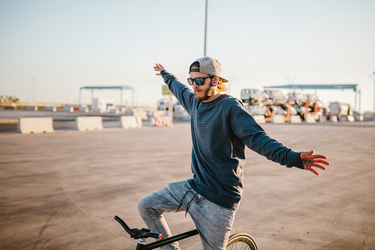 Young man balancing on bicycle