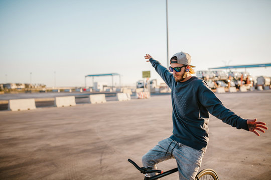 Young man balancing on bicycle