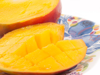 Ripe Mango with slices on plate. close up