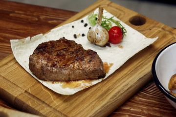 juicy grilled steak with fried potatos pepper tomato and garlic.