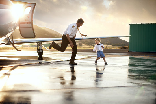 Pilot playing with boy at airport