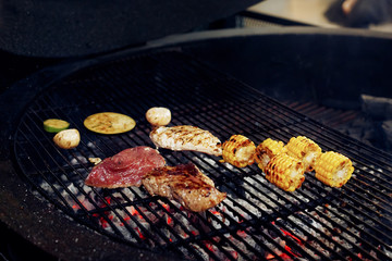 vegetables and meat grilling.  mushrooms corn pepper tomatos gar