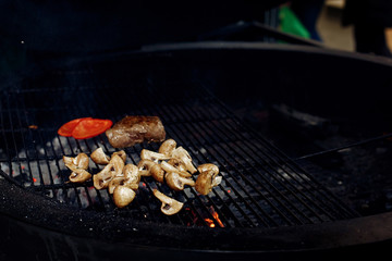 vegetables and meat grilling.  beefsteak mushrooms  tomatos garl