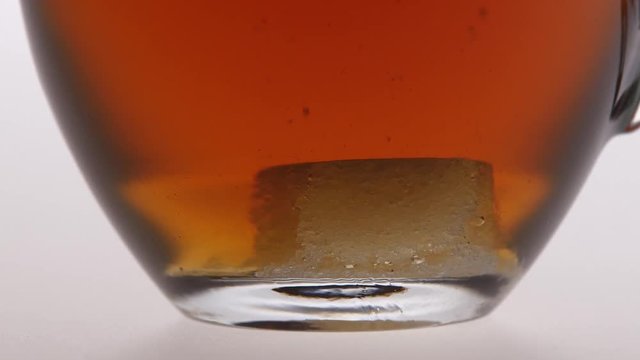 Time lapse. Sugar is dissolved in the cup of tea