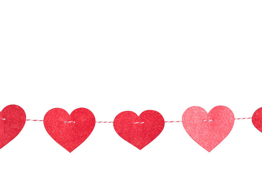 Small Red Hearts with Stitches Hanging on a String with Clothespin above wall on Light white Background