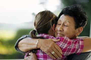 Granddaughter hugging her grandmother