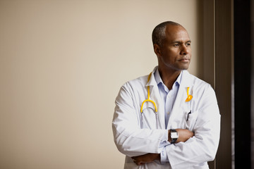 Thoughtful male doctor looking away