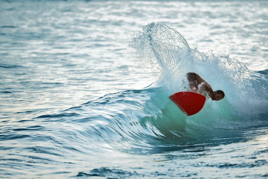 Young man surfing on the sea.