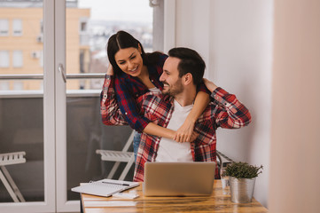 Couple hugging at home