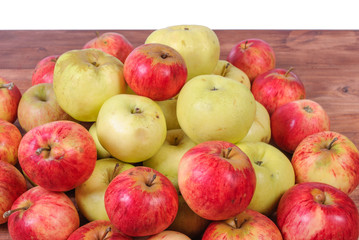 Whole red and green apples on a wooden background