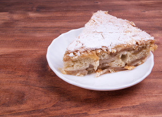Plate of cake sprinkled with powdered sugar krutnym up
