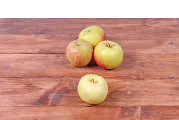 pile of green apples lying on a wooden background
