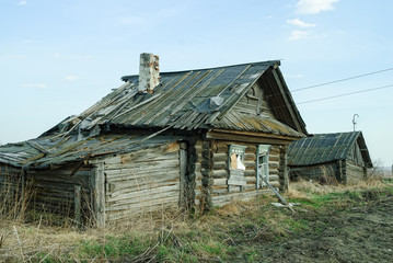 Fototapeta na wymiar Wooden abandoned old house with the driven-in windows in Preobrazhenskoe. Tyumen region. Russia