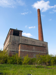 abandoned factory with high chimney