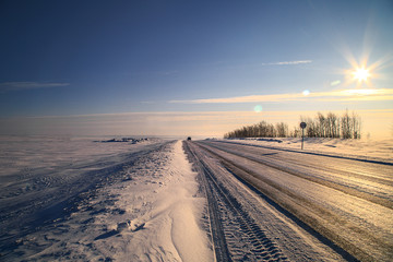 Fototapeta na wymiar Rural winter highway on a sunny day