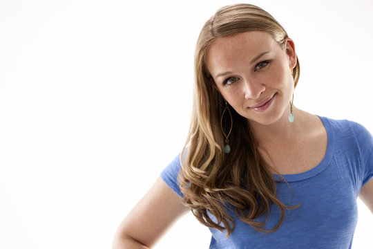 Portrait of smiling mid-adult woman wearing drop earrings.