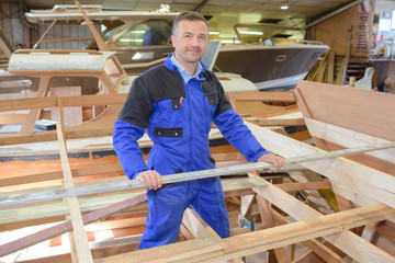 Fototapeta premium Carpenter working in boat yard