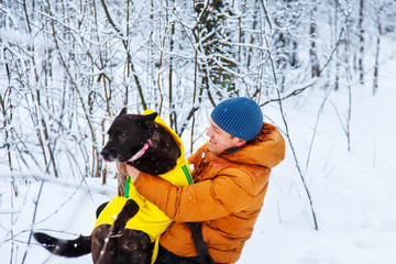 Fototapeta na wymiar Man walk the dog in the winter forest.