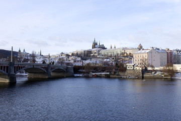 Snowy freeze Prague Lesser Town with gothic Castle above River Vltava, Czech republic