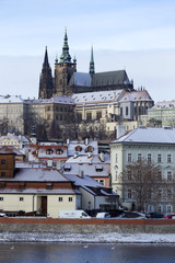 Snowy freeze Prague Lesser Town with gothic Castle above River Vltava, Czech republic