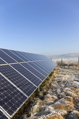 Solar Power Station in the snowy freeze winter Nature