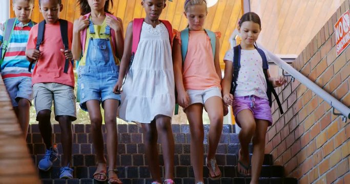 Slow motion of school kids getting down from staircase at school 4k