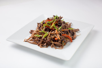 Buckwheat noodles with chicken teriyaki on a white background