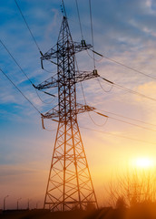 Electricity Pylon over orange sunset sky