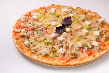 Pizza with cheese, tomatoes and chicken on a white background