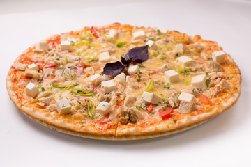 Pizza with cheese, tomatoes and chicken on a white background