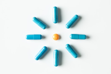Blue medical pills and capsules pattern on white background. flat lay, top view.