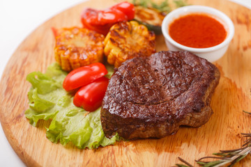 ribeye steak grilled with rosemary on a wooden