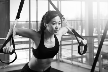 Young woman training in gym. Black and white photo