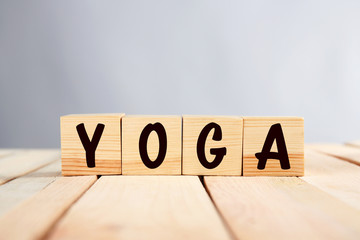 Sport concept. Word YOGA of cubes on wooden table