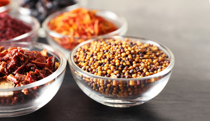Various spices in glass bowls, closeup