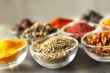 Various spices in glass bowls, closeup
