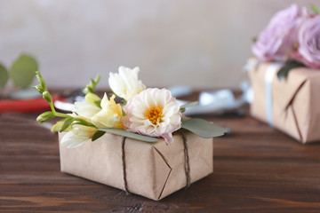 Box decorated with flowers on table