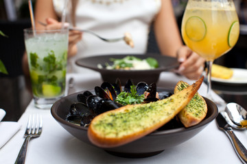 Woman eating seafood in a restaurant.