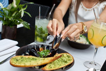 Woman eating seafood in a restaurant.
