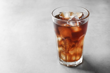 Glass of cold coffee on table