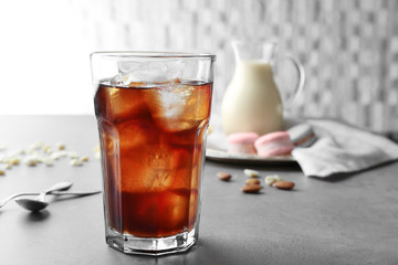 Glass of cold coffee on table