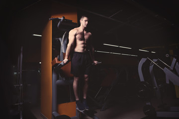 Young handsome man training in gym