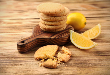 Fototapeta na wymiar Composition of cookies and lemons on wooden background
