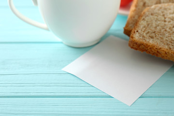 Cup of tea with tasty breakfast on wooden background