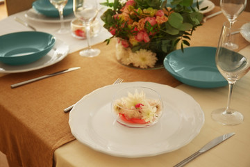 Elegant table setting with beautiful flowers, closeup