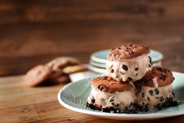 Delicious cookies with ice cream and chocolate chips on plate
