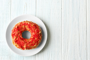 Glazed donut on wooden background