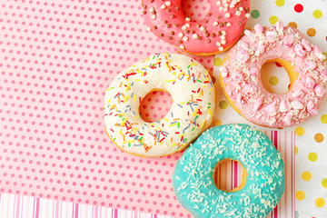 Delicious donuts on colorful background