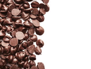 Tasty chocolate chips on white background